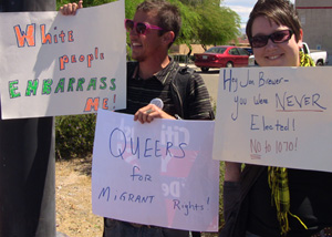 Queer protesters display signs